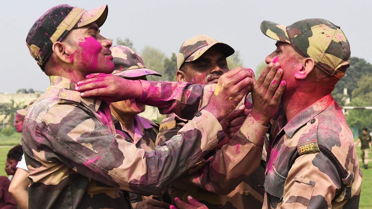 Border Security Force (BSF) personnel play with colours at battalion headquarter in Ajnala village, some 28 Km from Amritsar. Credit: AFP Photo