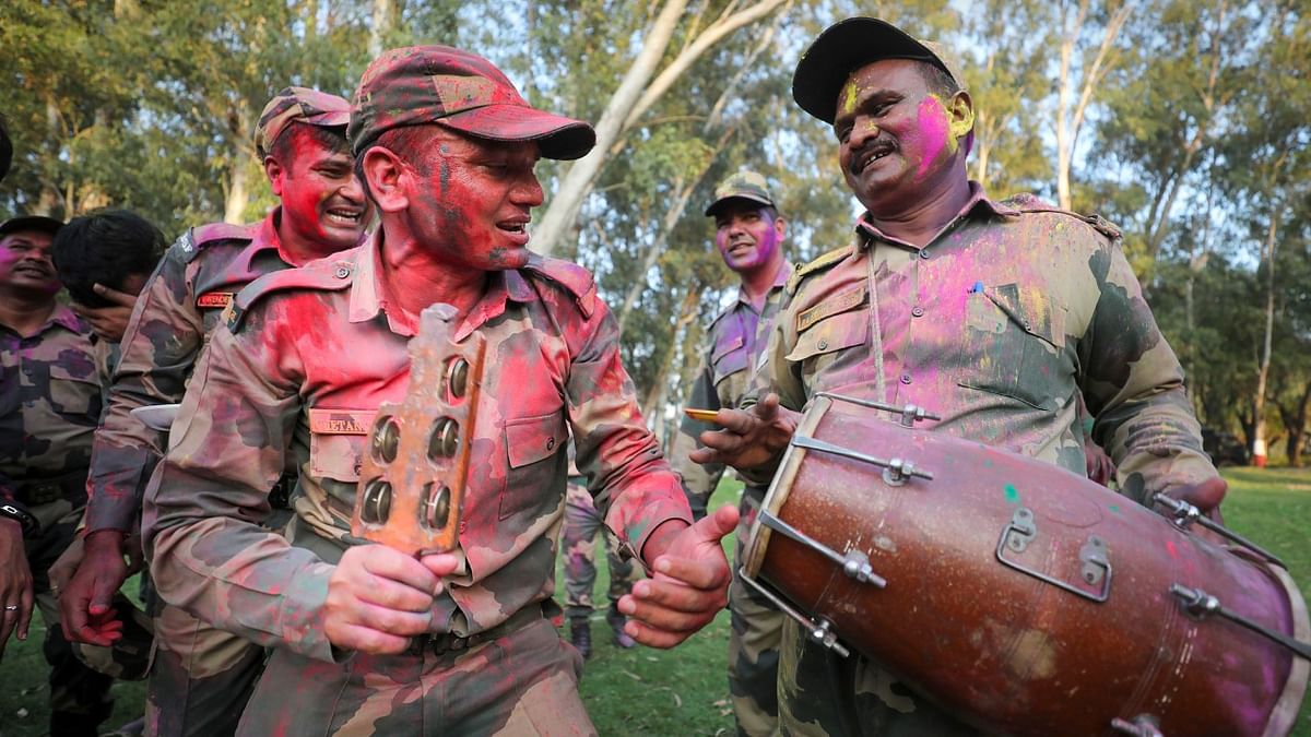 Indian Border Security Force (BSF) soldiers play with colours and dance to celebrate the festival of 'Holi' at the India-Pakistan border of Golpattan, in Jammu. Credit: PTI Photo