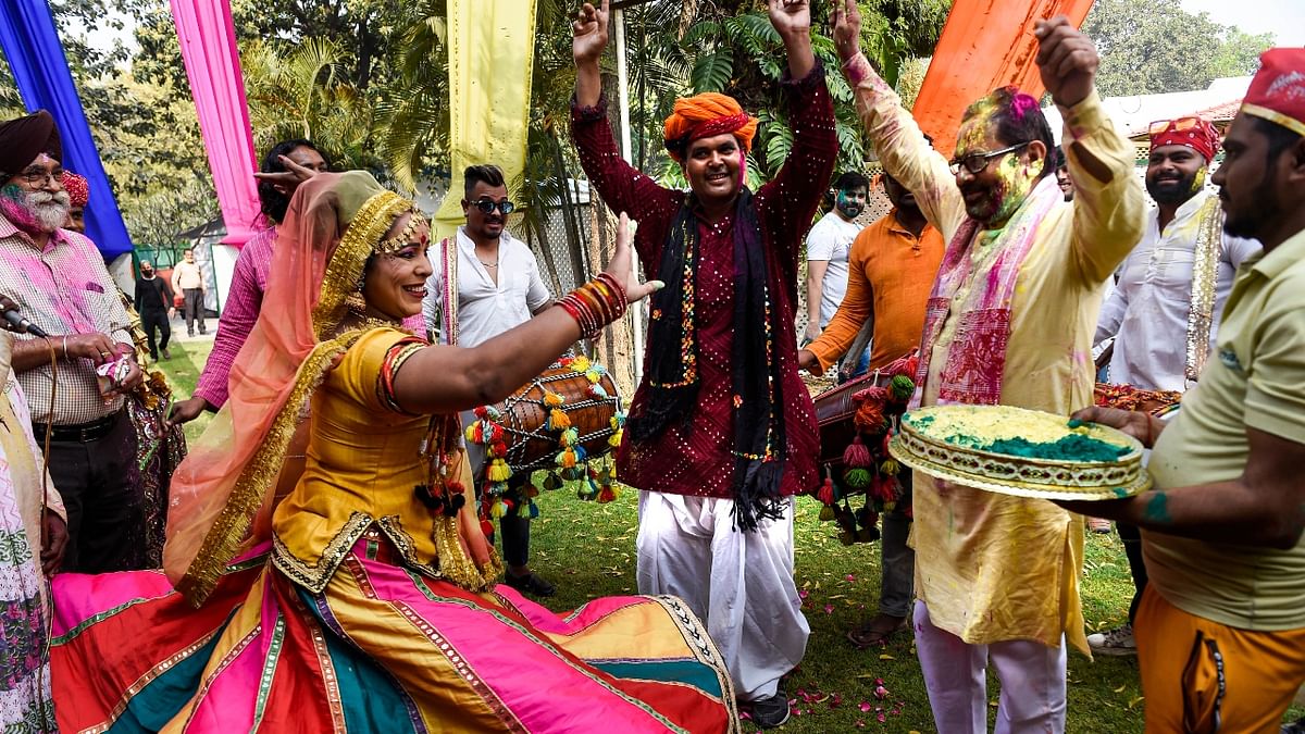 Union Minister Mukhtar Abbas Naqvi grooves to the dhol during the Holi celebrations at his residence in New Delhi. Credit: PTI Photo