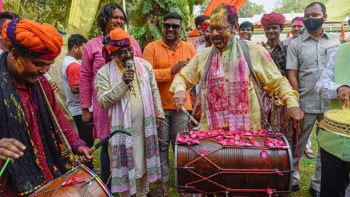 Mukhtar Abbas Naqvi also tried his hands playing the drums during the Holi festival at his residence in New Delhi. Credit: PTI Photo