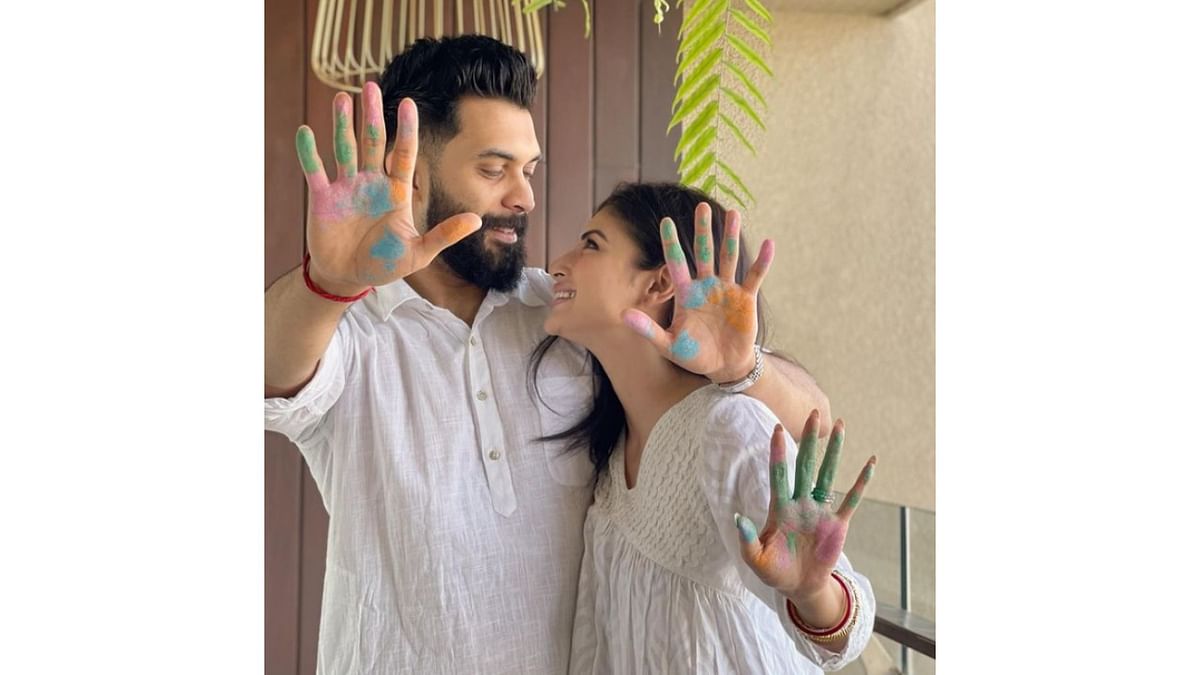 Popular TV actress Mouni Roy, who recently tied the knot with Dubai-based entrepreneur Suraj Nambiar in Goa, also shared pictures with hands smeared in coloured powder. Credit: Instagram/@imouniroy