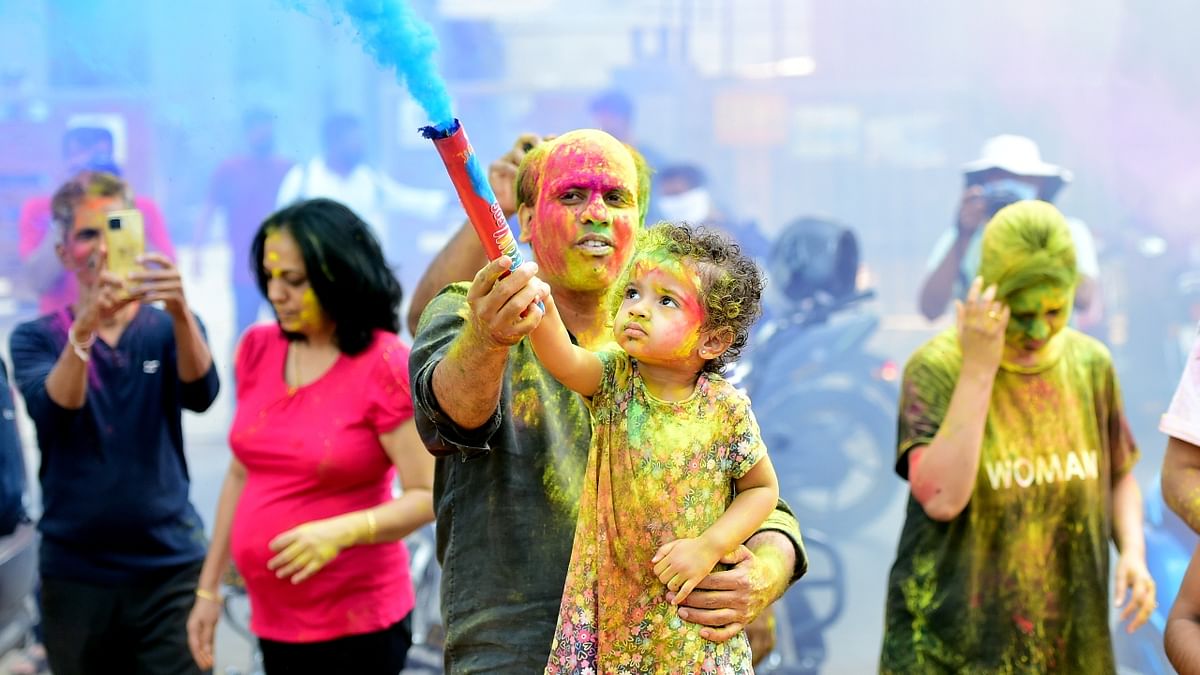 People play with colours during Holi festival in Mumbai. Credit: PTI Photo