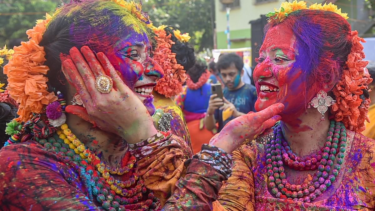 Students apply colours to each other during the Holi celebrations in Kolkata. Credit: PTI Photo