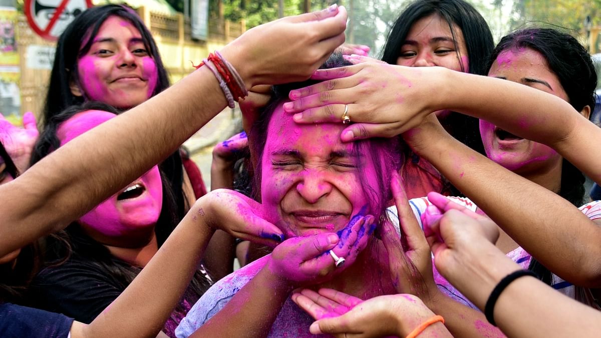 Students are seen playing with dry colours during the Holi festival in Guwahati. Credit: PTI Photo