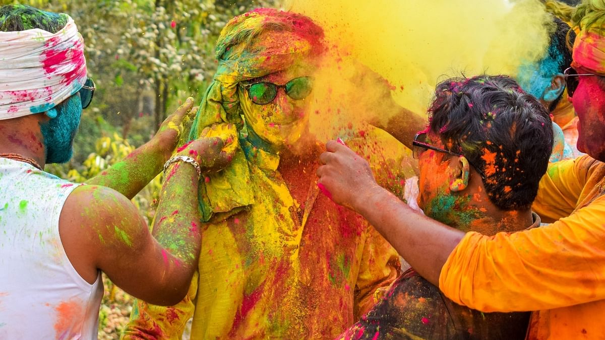 People play with dry colours during Holi festival, in Nadia, West Bengal. Credit: PTI Photo