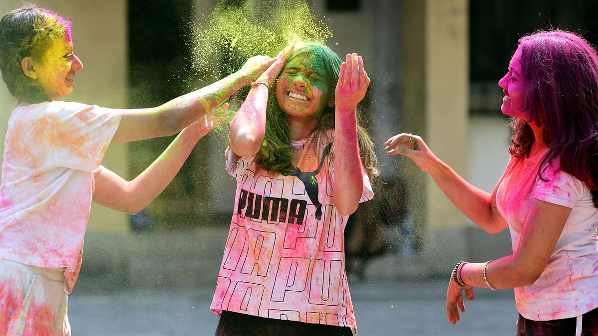 People play with dry colours during the Holi festival in Mumbai. Credit: PTI Photo