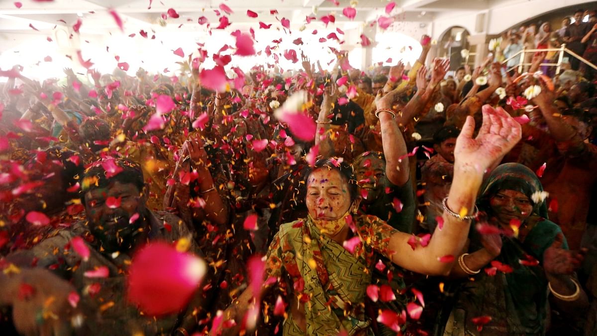 Devotees play Holi with flowers inside the Lord Jagannath Temple, in Ahmedabad. Credit: PTI Photo