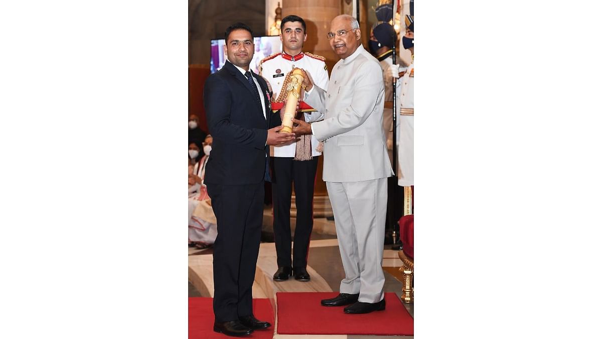 President Ram Nath Kovind presents Padma Shri to Jammu and Kashmir's Faisal Ali Dar, also known as Kashmir's 'Karate Kid'. Faisal is a martial arts coach from Bandipore. He established a sports academy and trained 4,000 students. He aims to empower the youth in the sensitive, militancy-hit regions with opportunities and dreams. Credit: PTI Photo