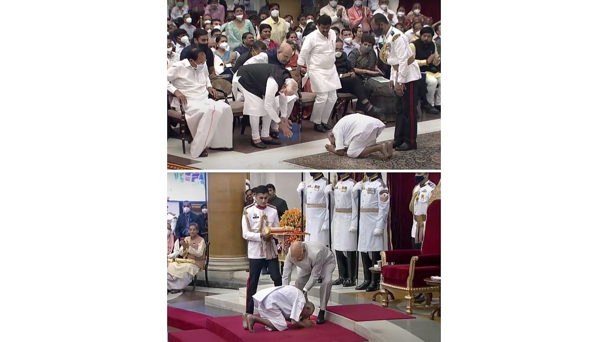 Members of the audience clapped as a bare-feet Sivananda, dressed in a simple white kurta and dhoti, knelt before Prime Minister Narendra Modi who promptly got up and bowed, touching the ground as he returned the greeting. Credit: PTI Photo