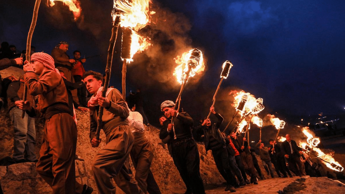 Iraqi Kurds holding lit torches walk up a mountain during celebrations of Noruz (Nowruz), the Persian new year, in the town of Akra, about 100 kilometres north of Arbil in Iraq's northern autonomous Kurdish region. Credit: AFP Photo
