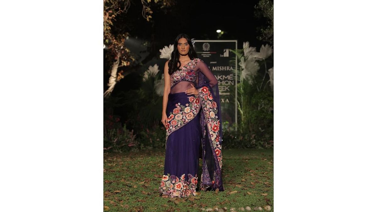 A model walks the ramp in an embroidered Rahul Mishra sari at FDCI X Lakme India Fashion Week. Credit: Instagram/fdciofficial