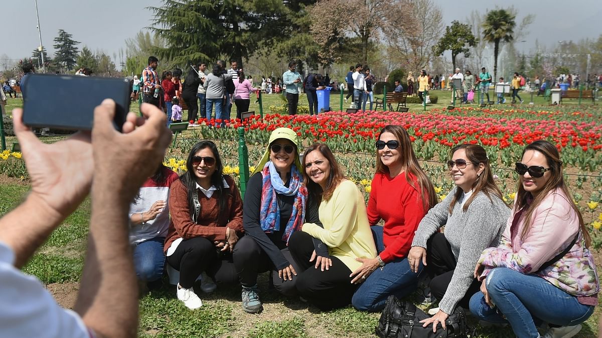 Tourists click photos at Asia's largest tulip garden in Srinagar. Credit: PTI Photo