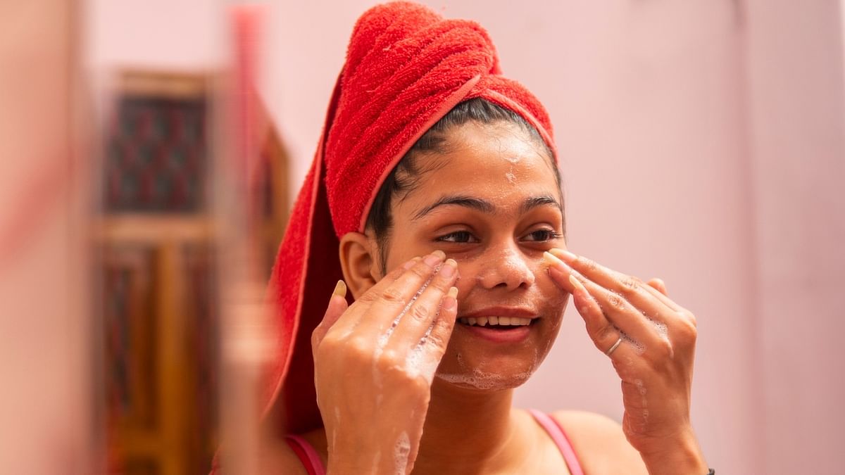 Cleanse your skin with a natural face wash that will help remove dirt and harmful chemicals from your face and prevent breakouts, follow this up with a gentle scrub that will help exfoliate the skin leaving it soft and supple. Credit: Getty Images
