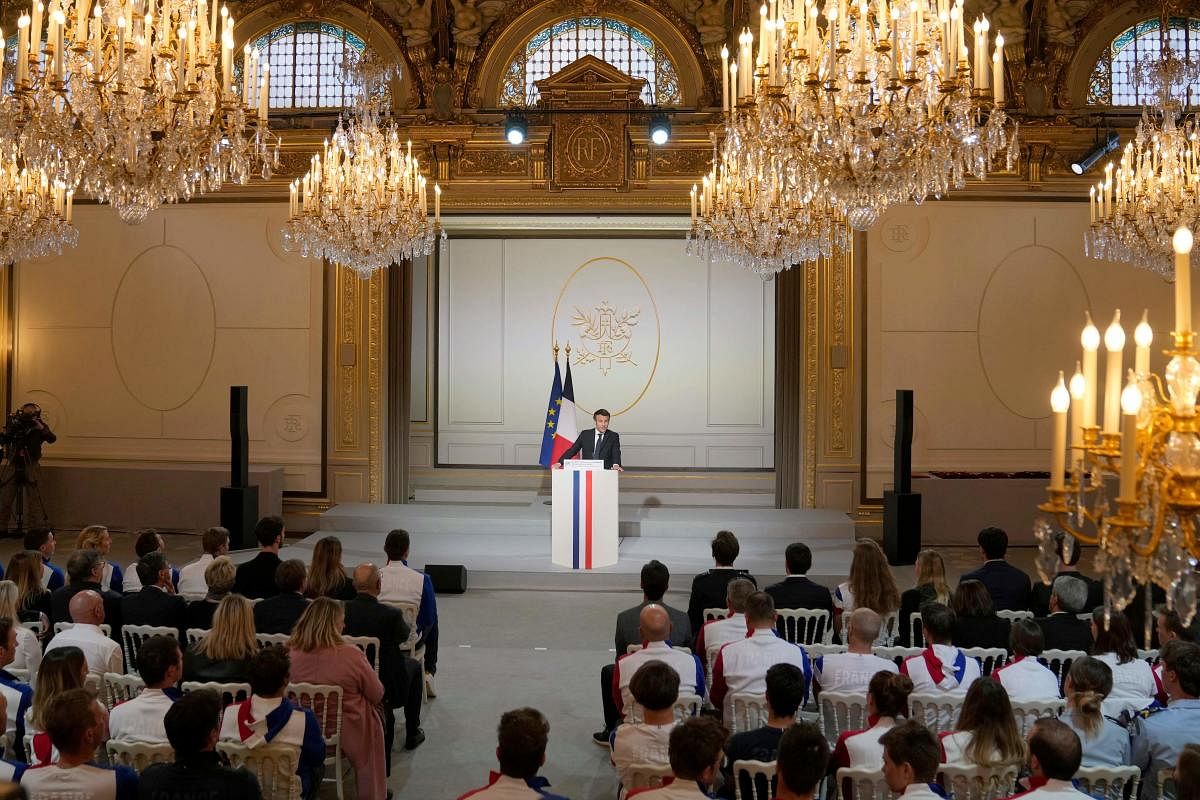 France's President Emmanuel Macron addresses a speech at the Elysee Palace during a ceremony to honor 28 French medal-winning athletes at the Winter Olympics and Paralympics, in Paris. Credit: AFP Photo