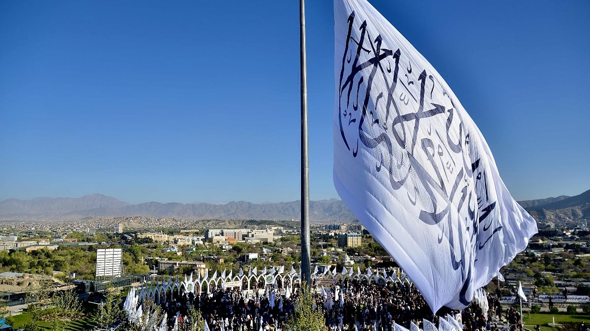 Measuring 40 metres (130 feet) wide and 26 metres high, the white flag is decorated with the Islamic profession of faith in black letters. Credit: AFP Photo