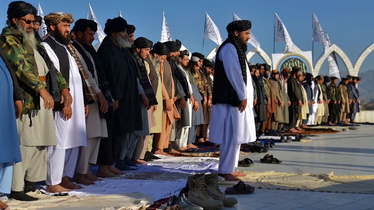 Members of Taliban offer prayers at the venue after a flag hoisting ceremony of the Taliban flag on the Wazir Akbar Khan hill in Kabul. Credit: AFP Photo
