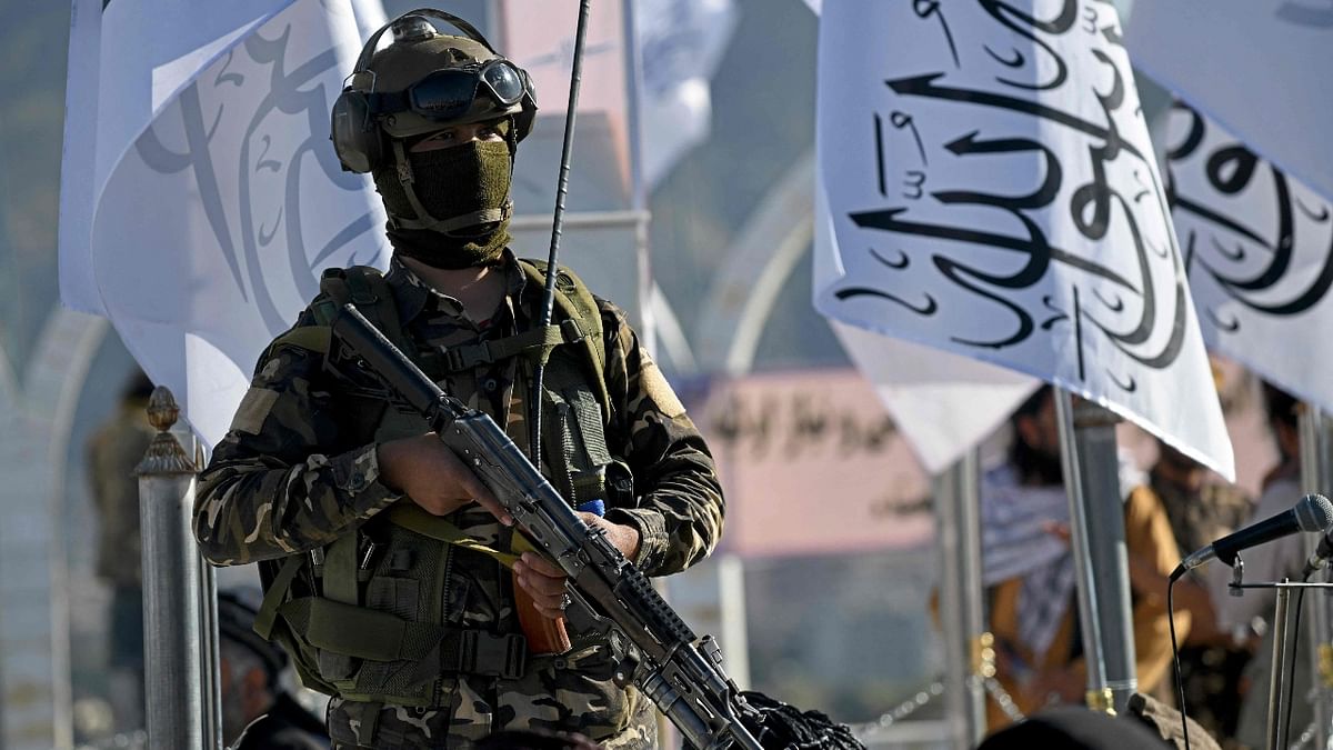 A Taliban fighter stands guard at the venue for a flag hoisting ceremony of the Taliban flag on the Wazir Akbar Khan hill in Kabul. Credit: AFP Photo