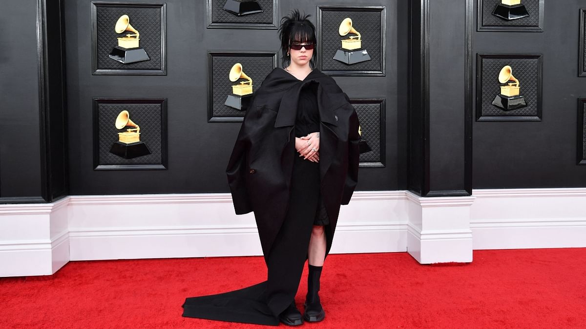 Singer Billie Eilish rocked in a deconstructed black suit jacket fashioned into a cape to match her hair and square sunglasses. Credit: AFP Photo