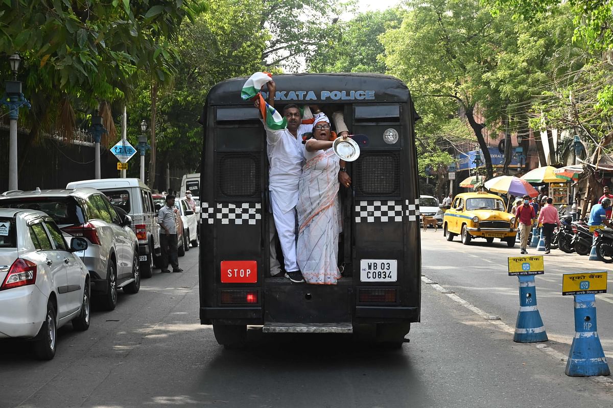 Congress workers shout slogans from a police van as they are detained during a demonstration against the hike in prices of fuel and other essential commodities in Kolkata. Credit: AFP Photo