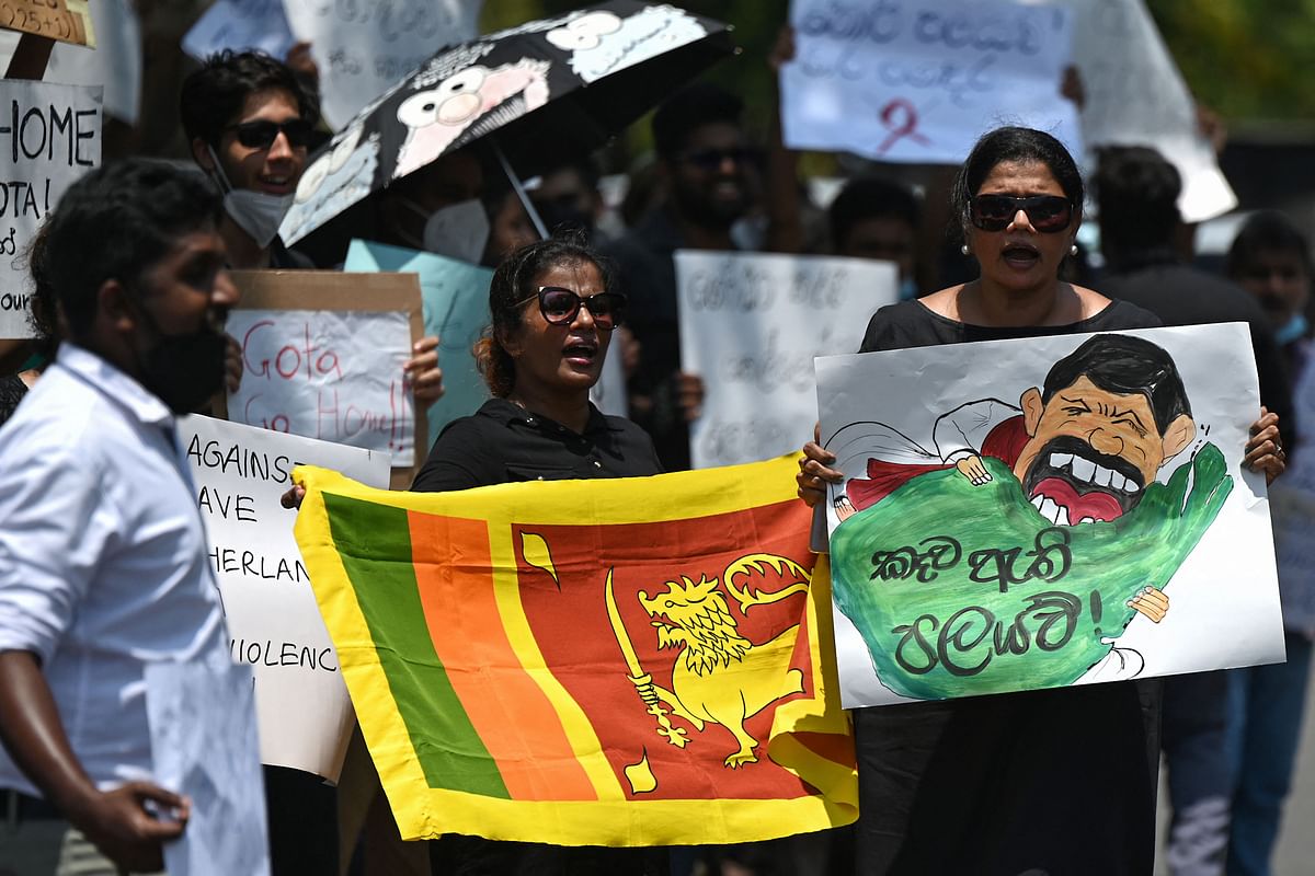 Protestors hold banners and placards during a demonstration against the surge in prices and shortage of fuel and other essential commodities in Colombo. Credit: AFP Photo