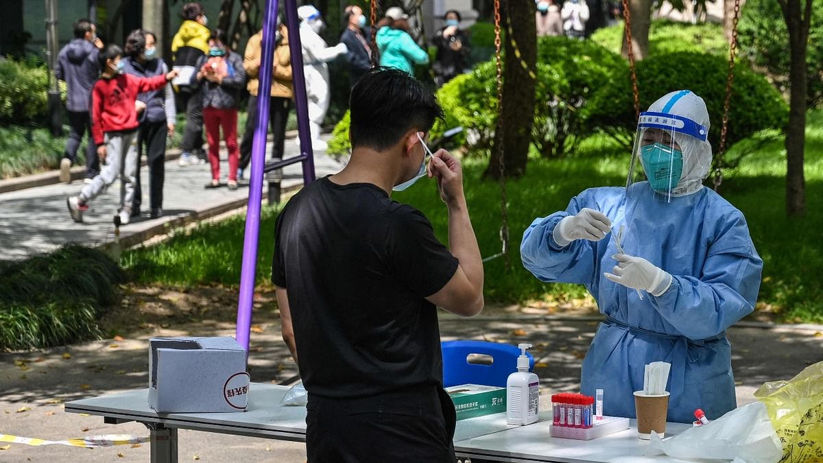 A health worker prepares to conduct a swab test at a residential compound during the second stage of a pandemic lockdown in Jing'an district of Shanghai. Credit: AFP Photo
