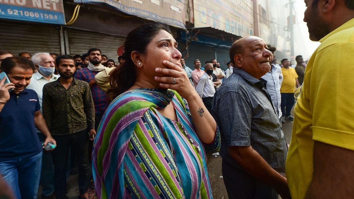 Owners react after their shops were gutted in the massive blaze. Credit: PTI Photo