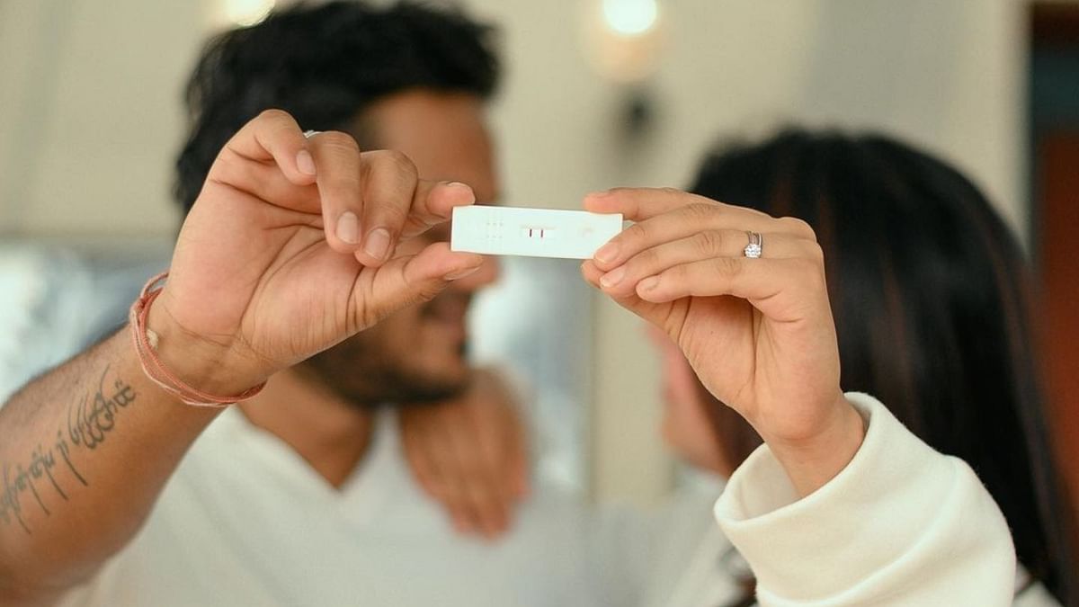 In one of the pictures, the couple is seen posing with a test device showing that she's pregnant. Credit: Instagram/pranitha.insta