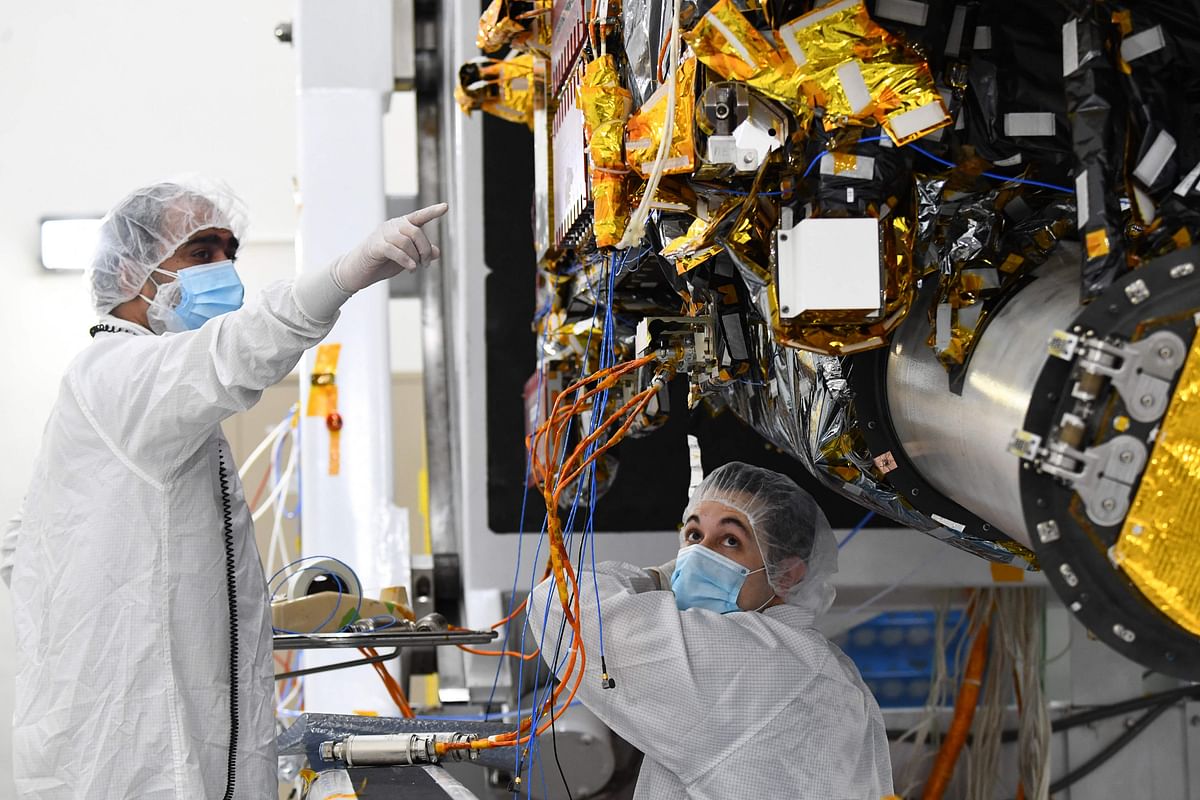 Workers prepare the Psyche spacecraft inside a clean room at NASA's Jet Propulsion Laboratory (JPL) in Pasadena. Credit: AFP Photo