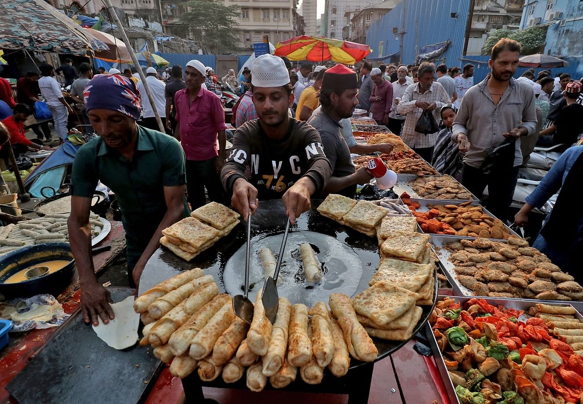A man fries snacks while waiting for people to purchase it for iftar meal during the Muslim fasting month of Ramadan in Mumbai. Credit: Reuters Photo