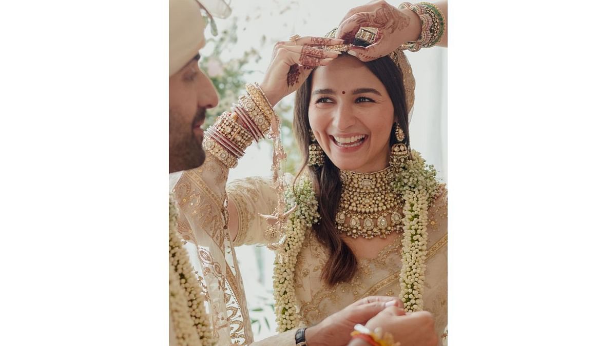 Alia Bhatt is the latest Bollywood star to get dressed by ace designer Sabyasachi for her wedding. Alia stole everyone's heart in a sublime ivory Sabyasachi saree with minimal make-up and heavy conventional jewellery. Credit: Instagram/aliaabhatt