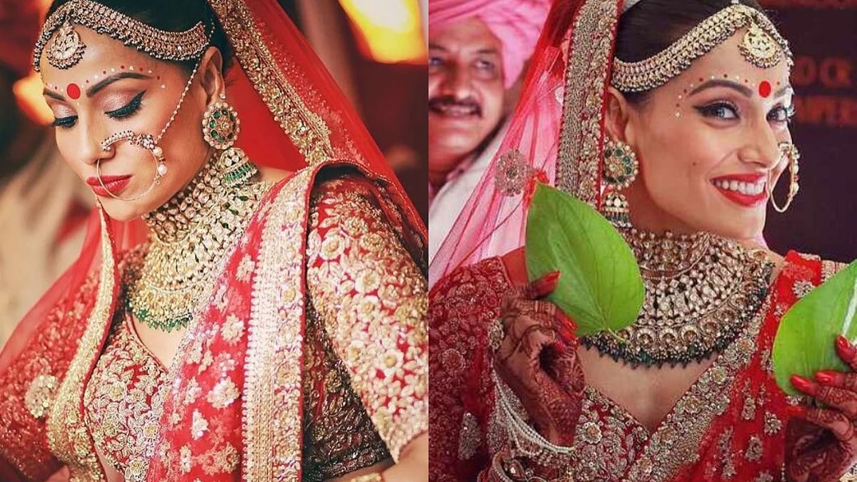 Bipasha Basu opted for a crimson Sabyasachi lehenga and went for a look with heavy bridal make-up. Credit: Instagram/bipashabasu