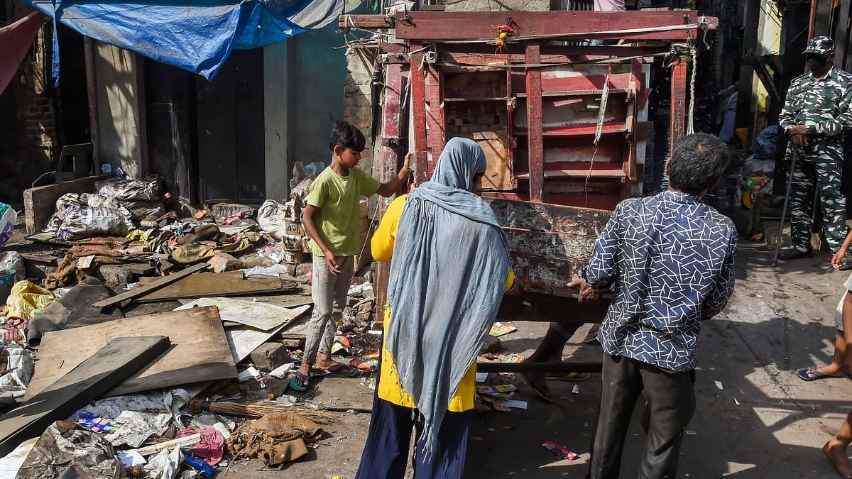 People shift their belongings during an anti-encroachment drive by the North Delhi Municipal Corporation (NDMC) in the violence-hit Jahangirpuri area, in New Delhi. Credit: PTI Photo