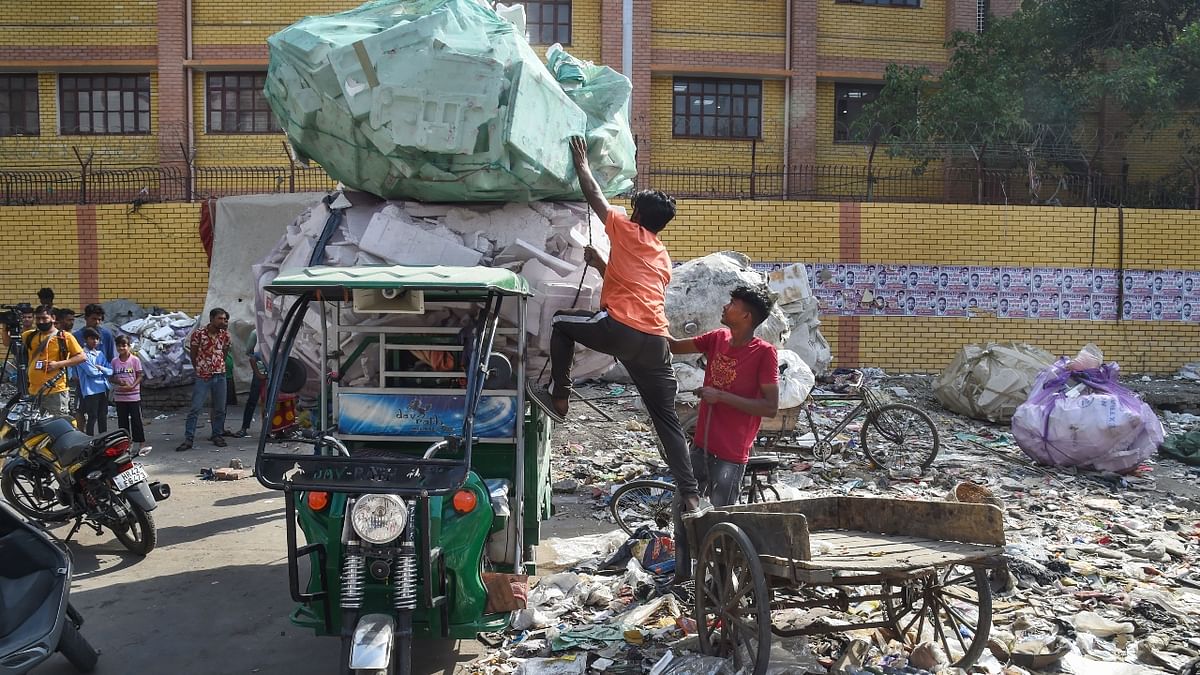 People shift their belongings to a safer place during an anti-encroachment drive by the North Delhi Municipal Corporation (NDMC) in Jahangirpuri. Credit: PTI Photo