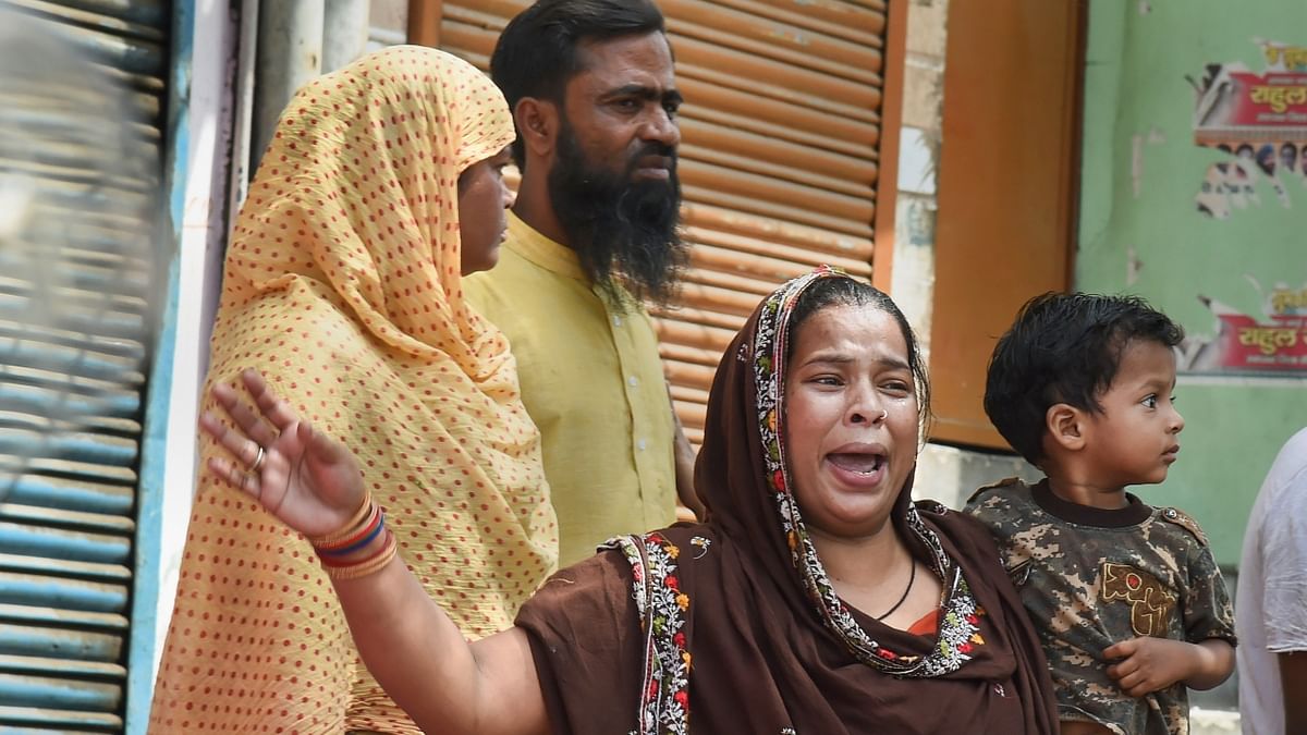 Locals react during a joint anti-encroachment drive by NDMC, PWD, local bodies and the police in Jahangirpuri. Credit: PTI Photo