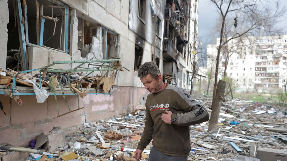 A Ukranian walks on the debris of a residential building damaged by a Russian military strike in Sievierodonetsk, Luhansk region. Credit: Reuters Photo