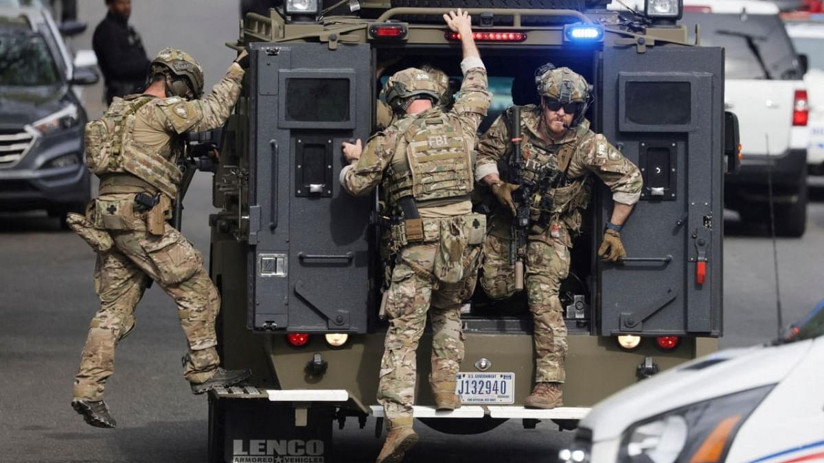 An FBI tactical team deploys from an armored vehicle at the scene of a reported shooting and active shooter near Edmund Burke Middle School in the Cleveland Park neighborhood of Northwest Washington. Credit: Reuters photo