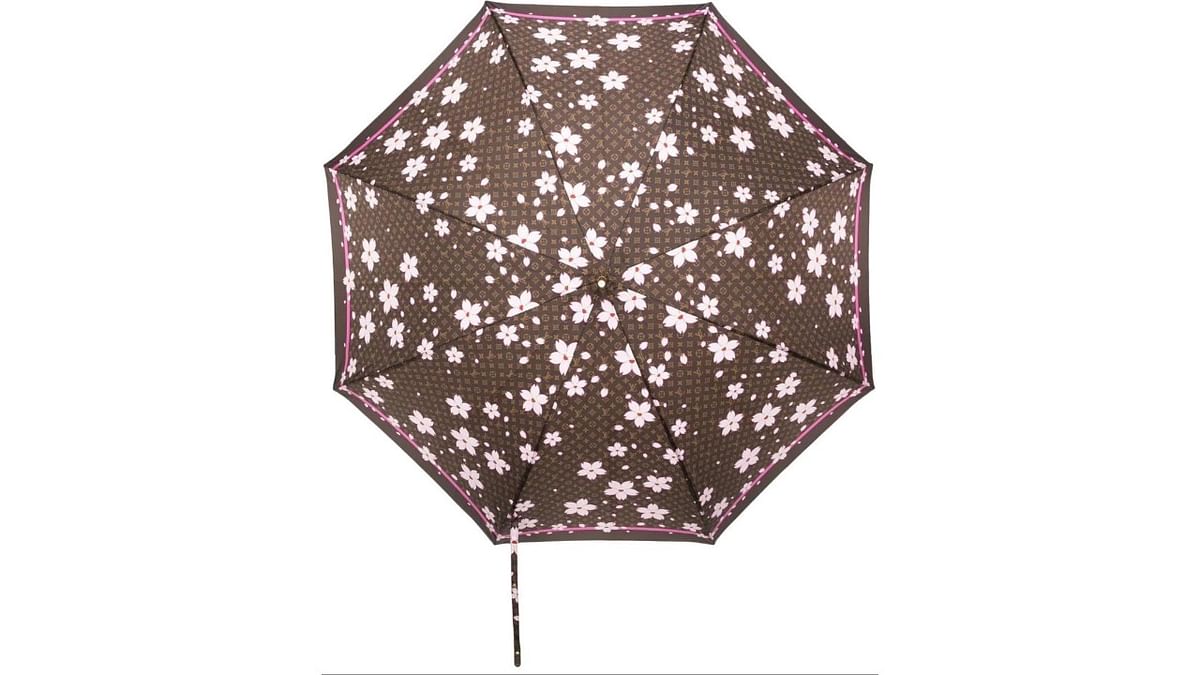 Cherry blossom print: This 2003 Cherry blossom umbrella from Louis Vuitton comes with a wooden handle. Its monogram print in brown, pink and white makes it a standout addition in your collection. It is priced at Rs 1.29 lakh. Credit: Farfetch.com