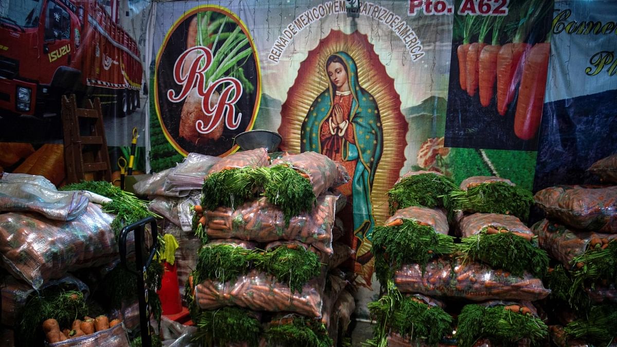 View of sacks of carrots for sale at a wholesale fruit and vegetables market in Lima. Credit: AFP Photo