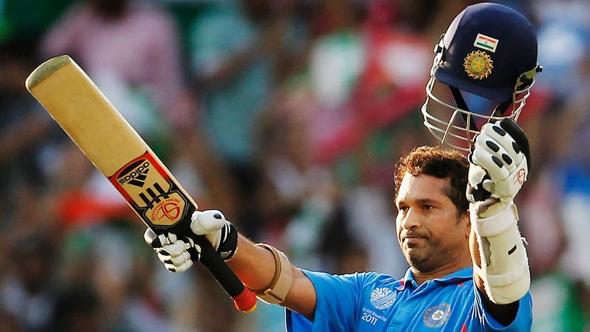 Sachin raises his bat on scoring his century during the Group B ICC World Cup Cricket match between India and South Africa at Vidarbha Cricket Association Ground on March 12, 2011. Credit: Getty Images