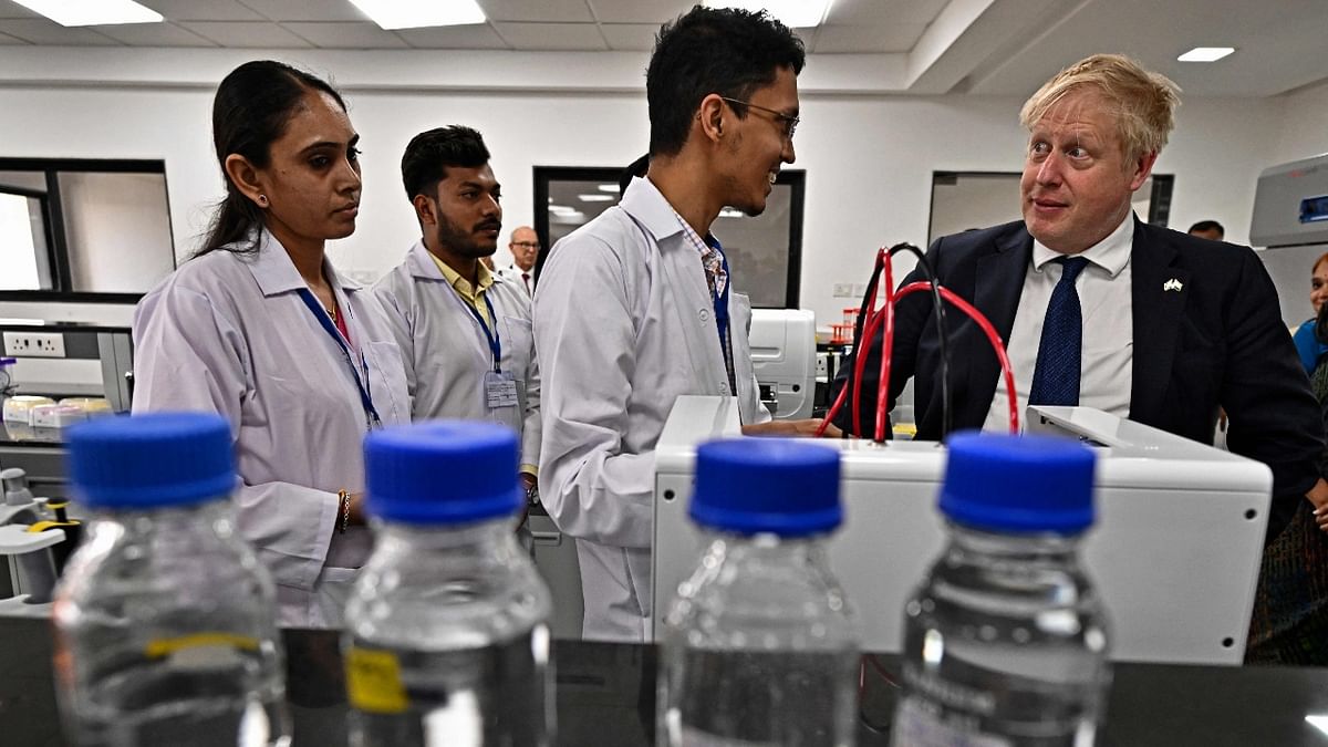 Boris is seen interacting with a student at the laboratory of the Gujarat Biotechnology University in Gandhinagar. Credit: AFP Photo