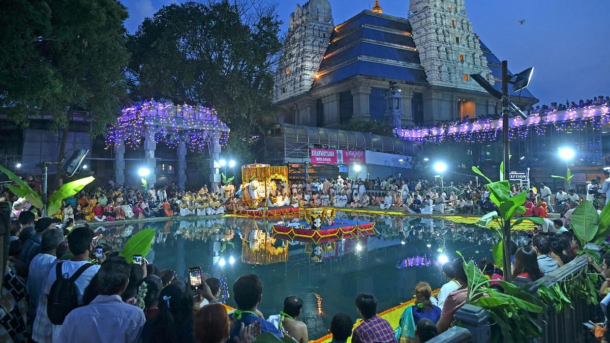 Devotees and volunteers carry an idol of Krishna as they conduct a ritual 'Theppotsavam', on a raft in a pond at ISKCON in Bangalore. Credit: AFP Photo