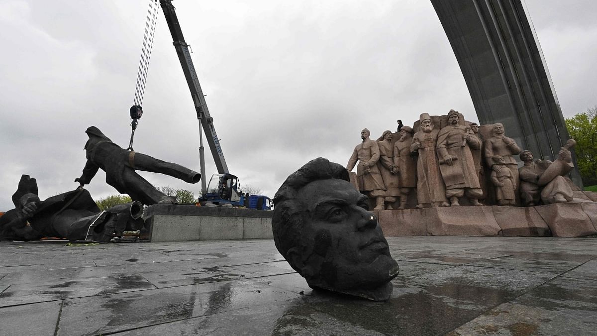Workmen started by removing one of the two bronze heads, which fell to the ground with a hollow clang. Credit: AFP Photo