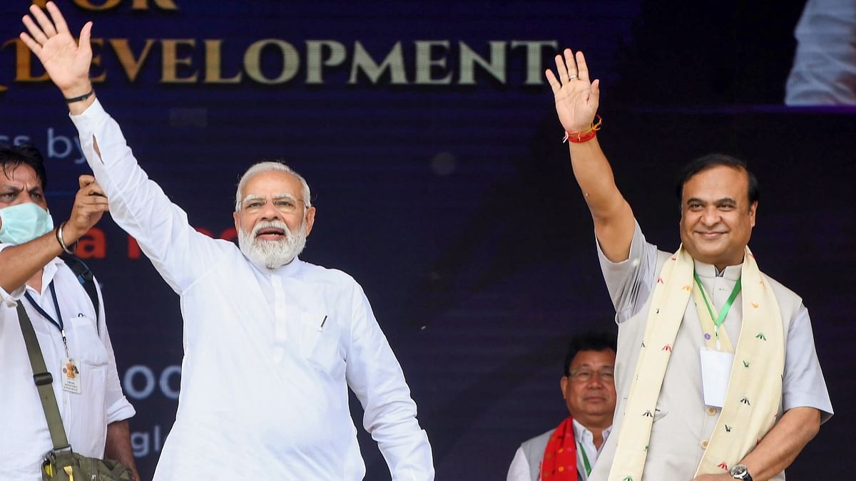 Prime Minister Narendra Modi and Assam CM Himanta Biswa Sarma greet the audience during the ‘unity, peace and development rally’ in Assam. Credit: PTI Photo