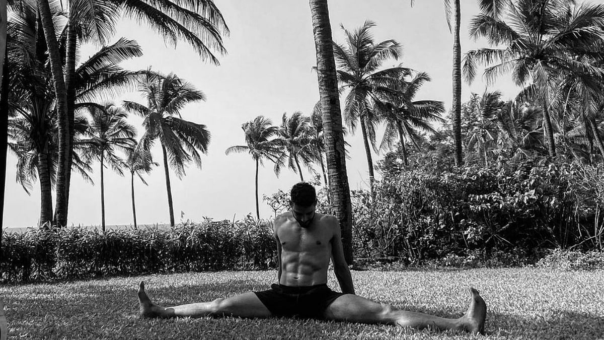 Bollywood actor Siddhant Chaturvedi is known for his well-maintained physique. In this photo, he is seen doing full split! Credit: Instagram/siddhantchaturvedi