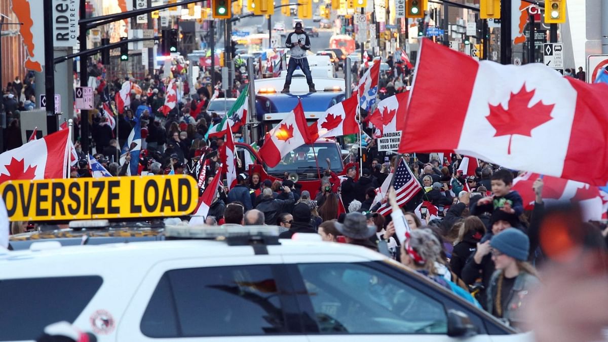 A police car blocks the street as supporters of the Rolling Thunder Convoy turn out in large numbers for a demonstration in downtown Ottawa, Canada. Credit: AFP Photo