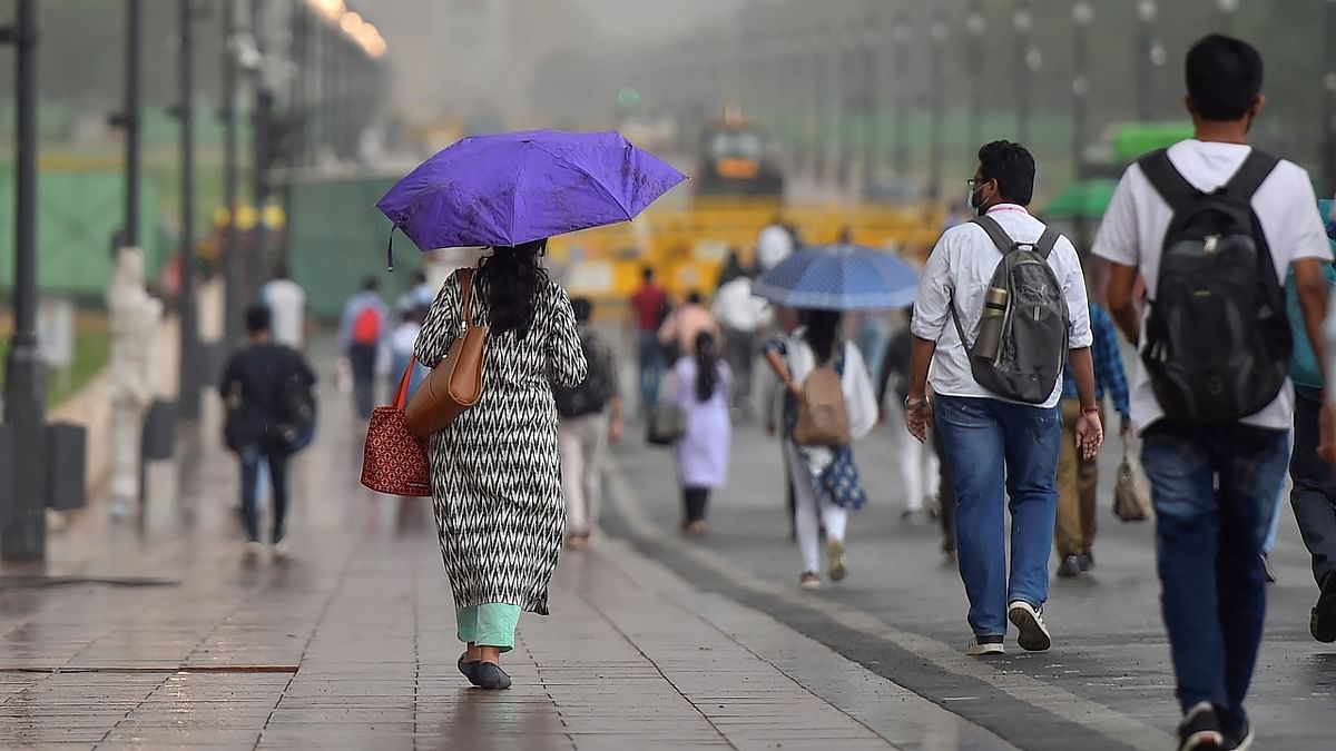 People taking a stroll in the rains. Credit: PTI Photo