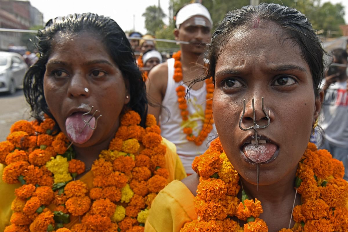 Devotees with their tongues pierced with tridents take part in a procession to honour the Hindu goddess Mariamman in Amritsar. Credit: AFP Photo