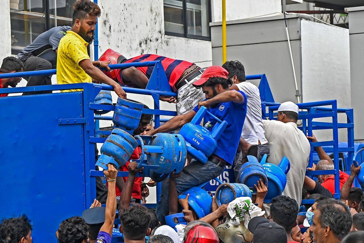 Enraged crowd loot a truck transporting cooking gas cylinders in Colombo. Credit: AFP Photo