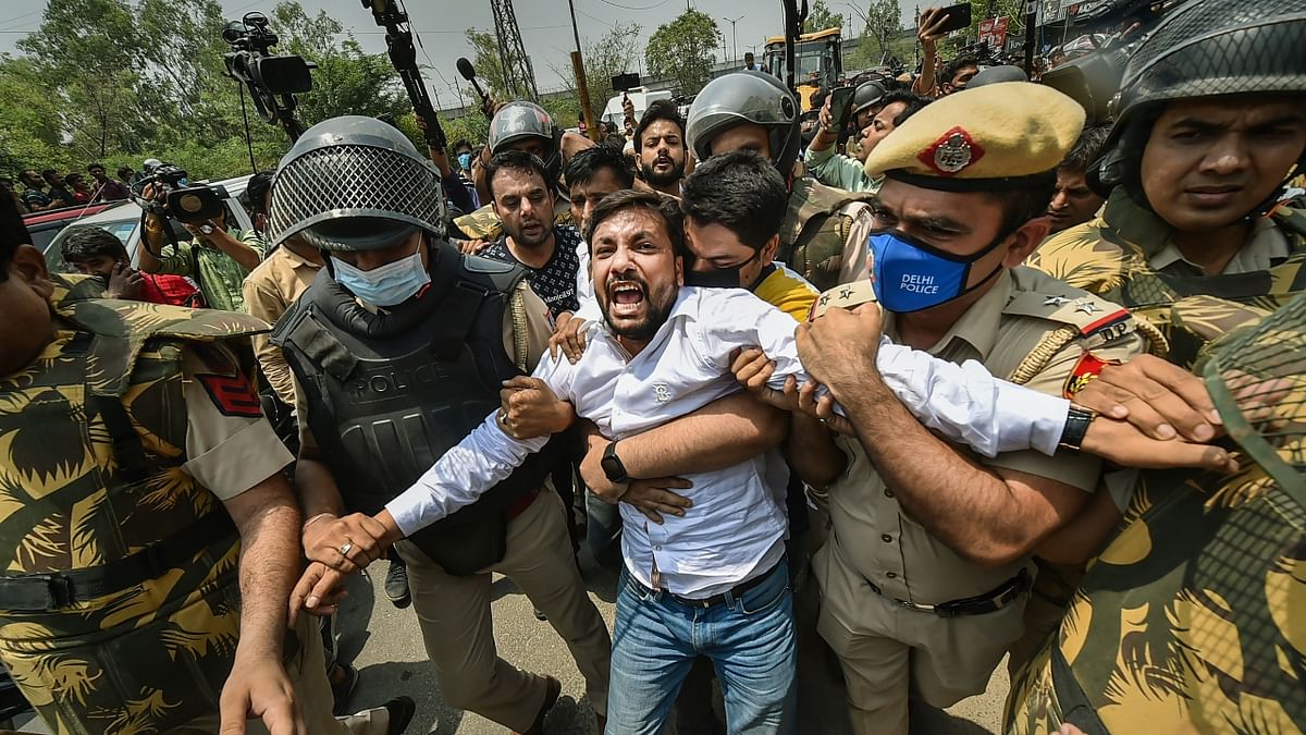 Delhi Police personnel seen stopping a local resident from staging the protest at Shaheen Bagh in Delhi. Credit: PTI Photo