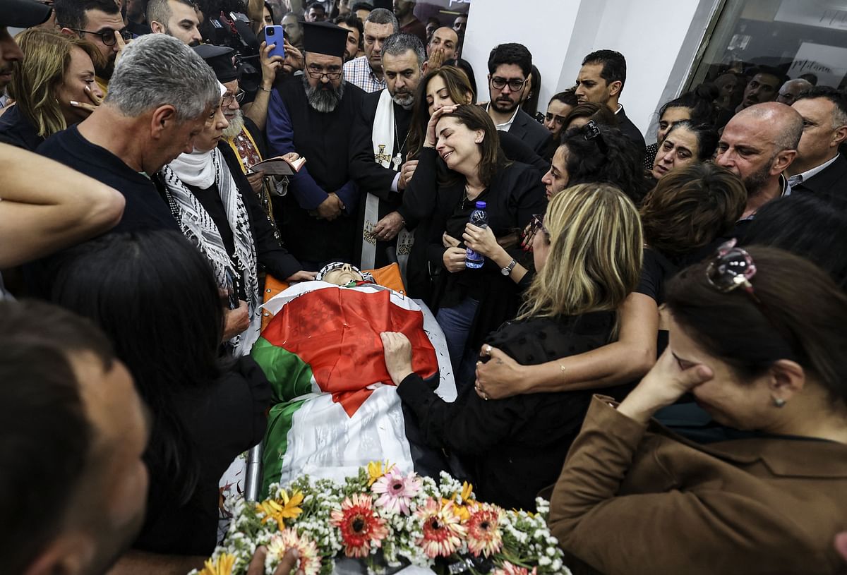 Colleagues and friends react as the corpse of veteran Al-Jazeera journalist Shireen Abu Akleh is brought to the offices of the news channel in the West Bank city of Ramallah. Credit: AFP Photo
